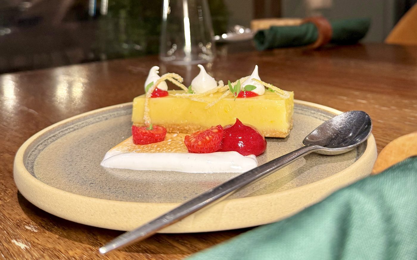 A seasonal dessert of lemon tart with strawberries and meringue
