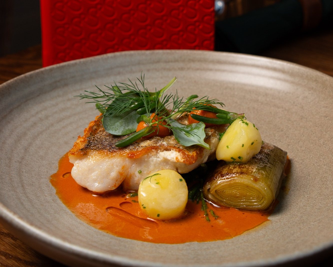 Cornish Hake with Shellfish Bisque, Confit Potato and Samphire